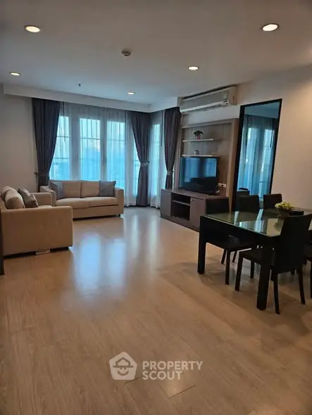 Spacious living room with modern furniture and large windows for natural light.