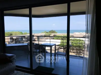 Stunning ocean view from modern balcony with seating area