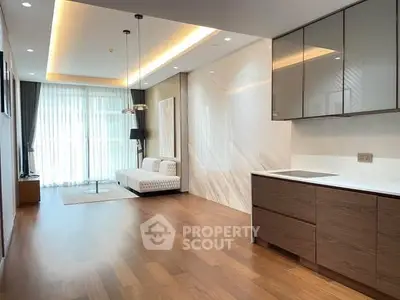 Spacious modern living room with open kitchen and elegant wooden flooring