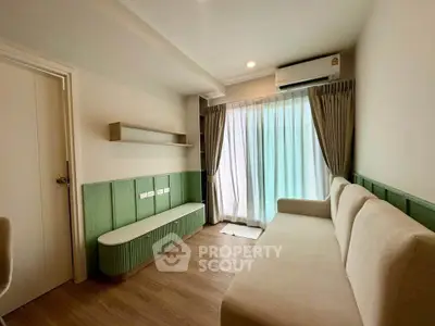 Modern living room with stylish sofa and air conditioning, featuring elegant wood flooring and natural light.
