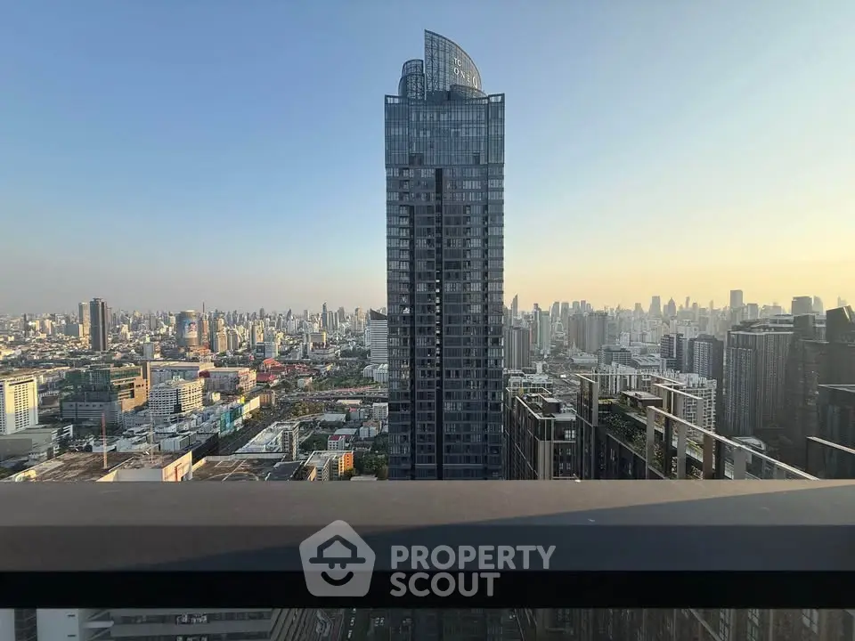 Stunning cityscape view from a high-rise balcony showcasing urban skyline and modern architecture.