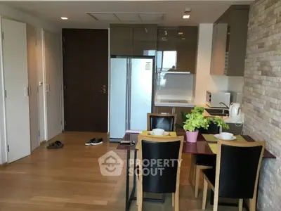 Modern kitchen with dining area and sleek appliances in a stylish apartment.