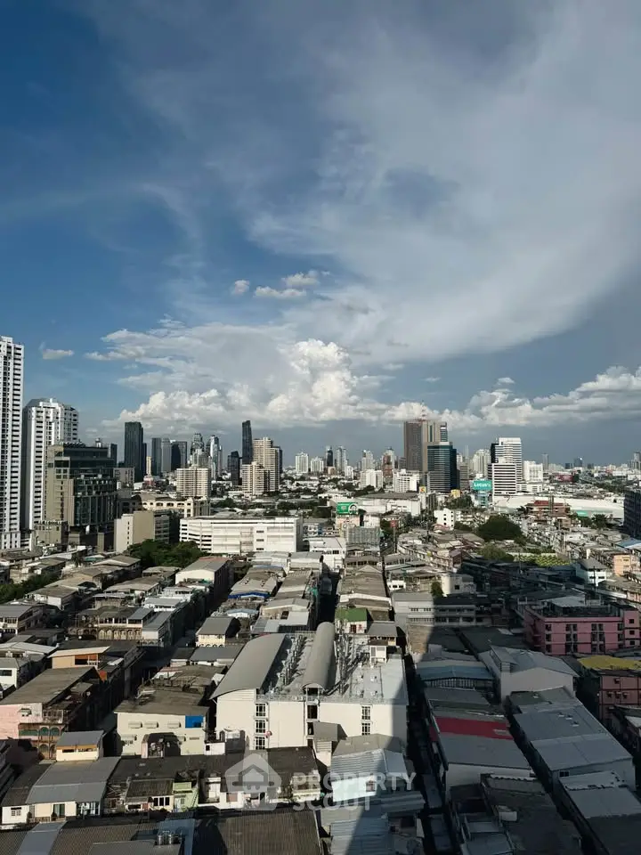 Stunning cityscape view showcasing urban skyline and residential buildings under a clear blue sky.