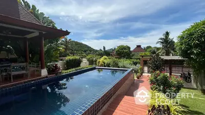 Luxurious villa with private pool and lush garden offering stunning mountain views.