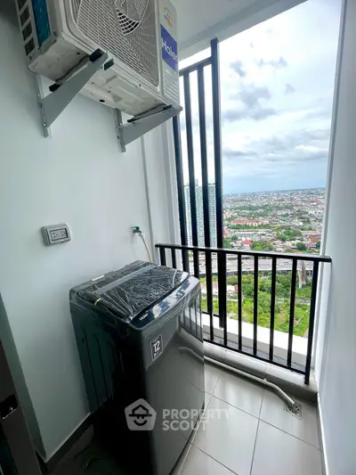High-rise apartment balcony with washing machine and stunning city view
