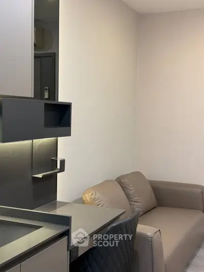 Modern compact living room with sleek furniture and integrated storage solutions.
