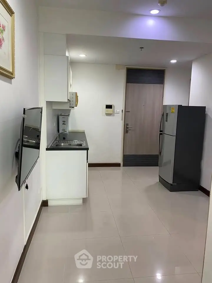 Modern kitchen with sleek appliances and open layout in a stylish apartment.