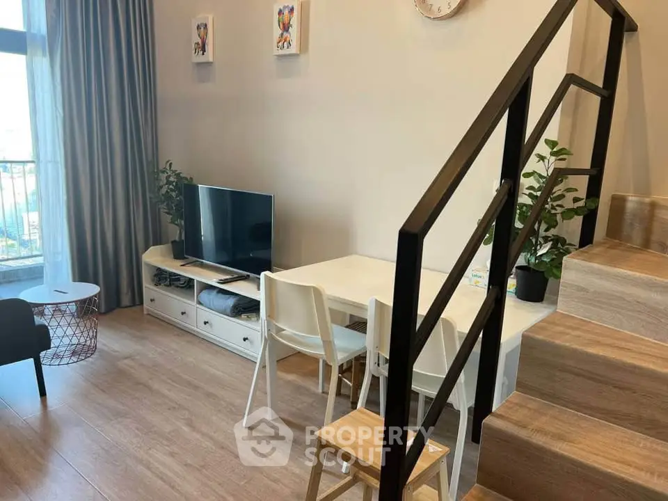 Modern living room with stylish staircase and cozy dining area, perfect for urban living.