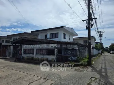 Charming suburban house with unique architectural design and spacious surroundings.