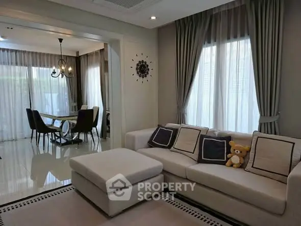 Elegant living room with plush sofa and dining area in modern home