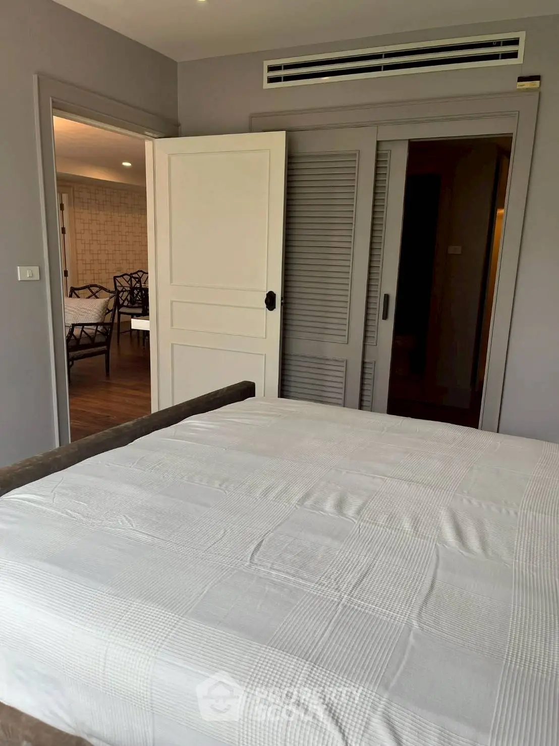 Spacious bedroom with modern design and adjoining room view
