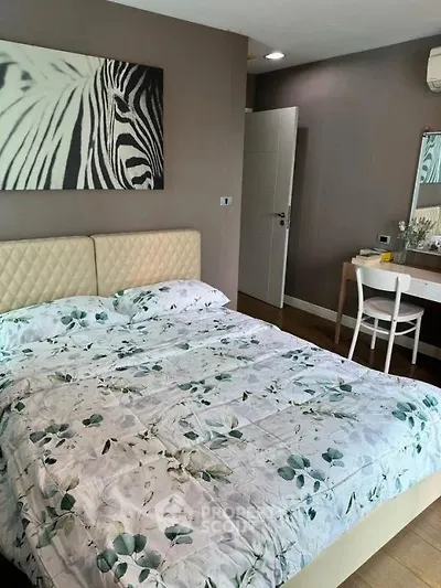 Cozy bedroom with stylish decor and comfortable bedding in modern apartment.