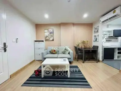 Modern living room with cozy sofa, dining area, and stylish decor in open layout apartment.