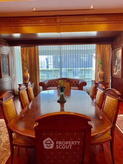 Luxurious dining room with elegant wooden furniture and large windows.