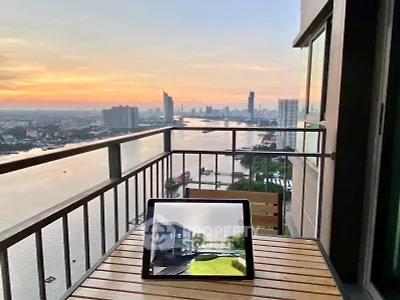 Stunning river view from high-rise balcony at sunset, perfect for relaxation.
