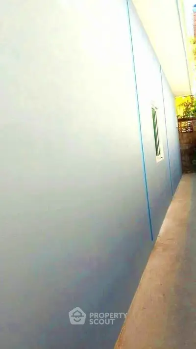 Modern exterior wall with sleek design and narrow pathway