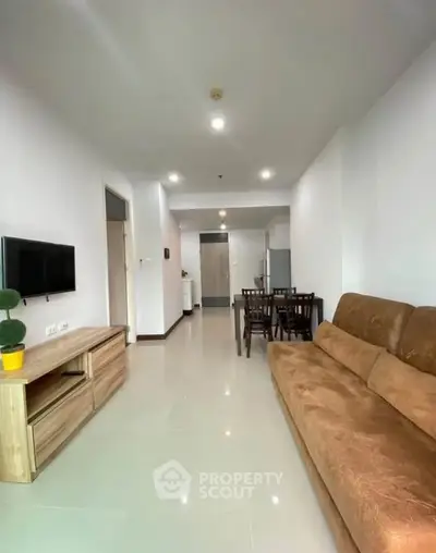 Spacious modern living room with sleek furniture and open layout, perfect for comfortable living.