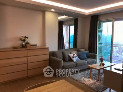 Modern living room with cozy sofa and balcony view in stylish apartment.