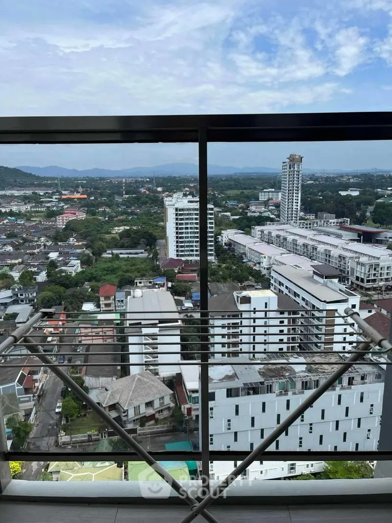 Stunning high-rise balcony view overlooking cityscape and lush greenery, perfect for urban living enthusiasts.