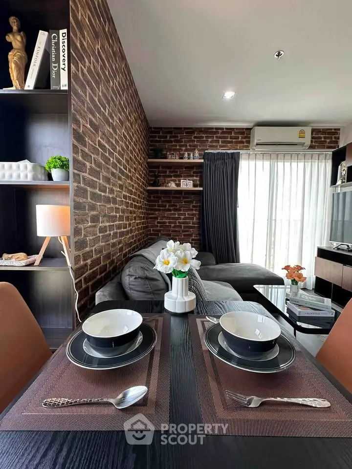 Stylish living room with exposed brick wall and modern decor, perfect for urban living.