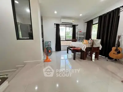 Spacious living room with dining area and musical ambiance