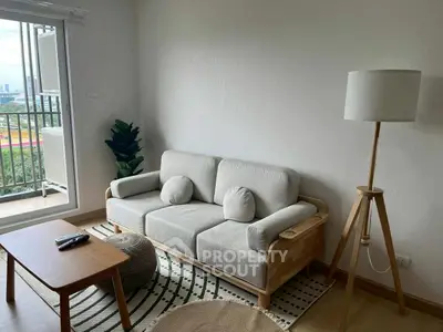 Modern living room with cozy sofa, stylish lamp, and balcony view in a chic apartment.