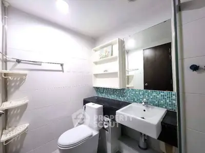 Modern bathroom with sleek fixtures and mosaic tile accents
