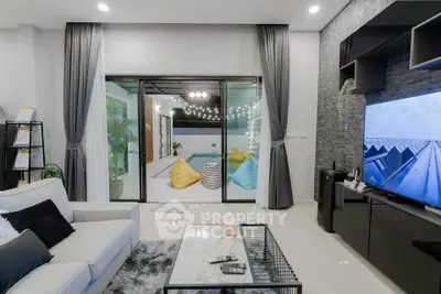 Modern living room with pool view and stylish decor