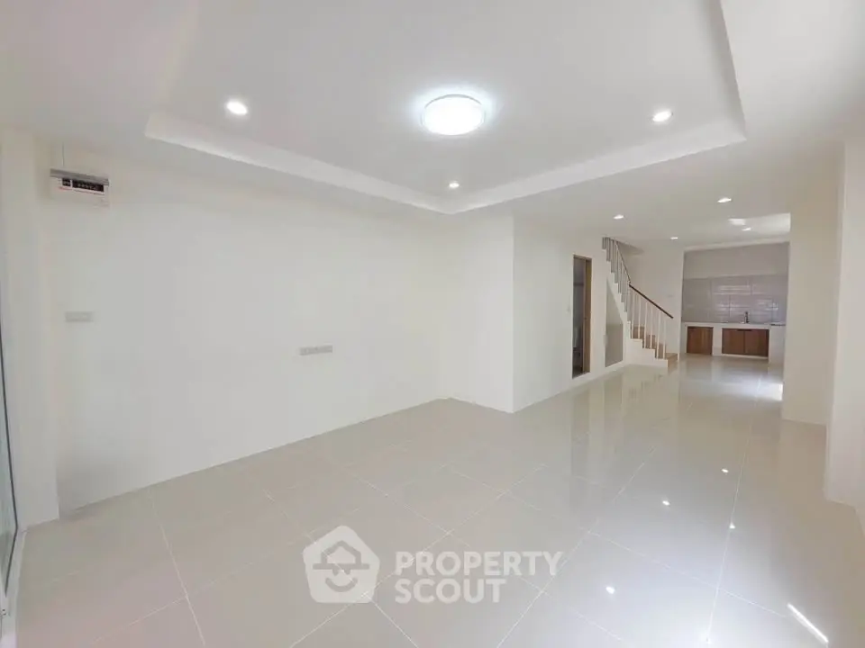 Spacious modern living room with sleek tile flooring and recessed lighting