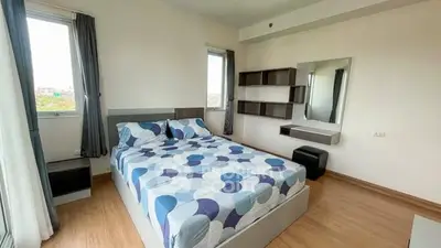 Modern bedroom with stylish decor and ample natural light