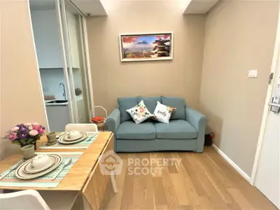 Cozy living room with modern decor and dining area in a stylish apartment.