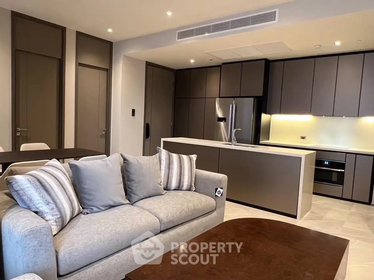 Luxurious modern open-layout kitchen and living room with sleek design and high-end appliances.