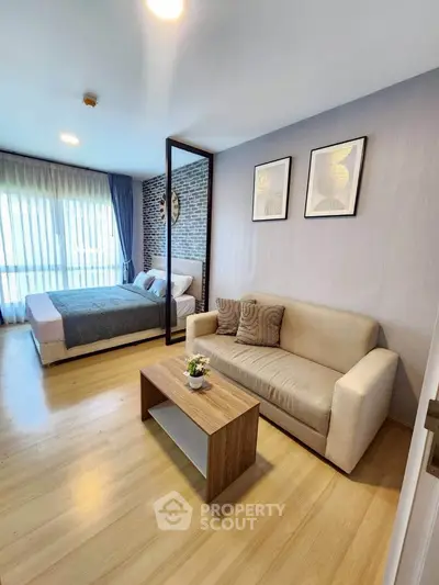 Modern studio apartment with cozy living area and stylish bedroom
