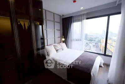 Modern bedroom with large window offering stunning city views, featuring sleek wardrobe and cozy bedding.