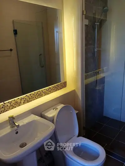 Modern bathroom with sleek fixtures and glass shower enclosure