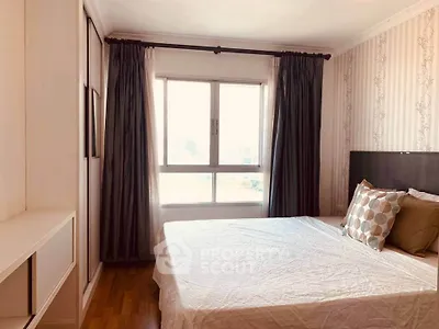 Bright and cozy bedroom with large window and stylish decor in modern apartment.