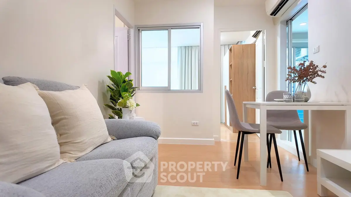 Modern living room with cozy sofa and dining area in bright apartment