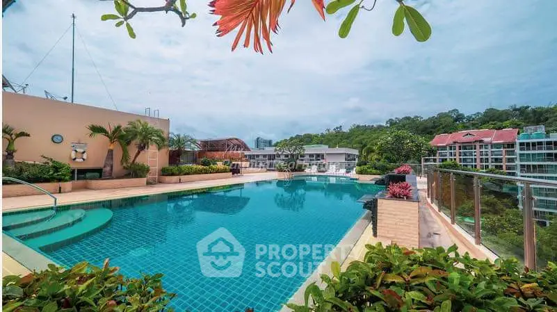 Luxurious rooftop pool with stunning city views and lush greenery, perfect for relaxation and leisure.