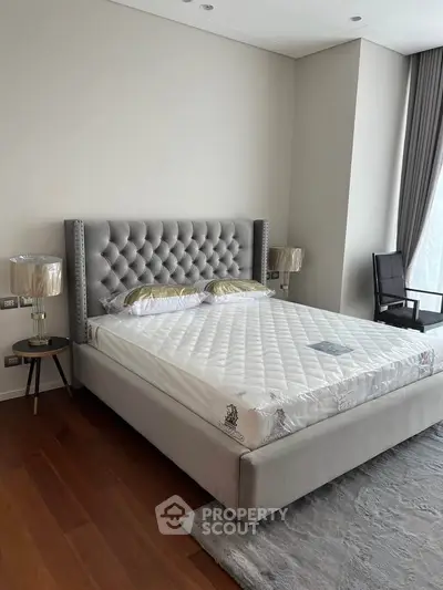 Luxurious bedroom with elegant gray tufted bed and stylish decor