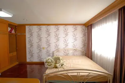 Cozy bedroom with natural light and wooden accents