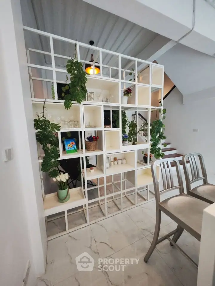 Modern interior with stylish shelving and sleek staircase in contemporary home