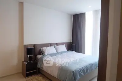 Modern bedroom with cozy bed and stylish decor in a contemporary apartment.