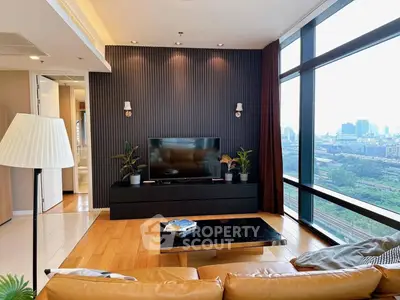 Modern living room with city view, featuring sleek decor and large windows for natural light.