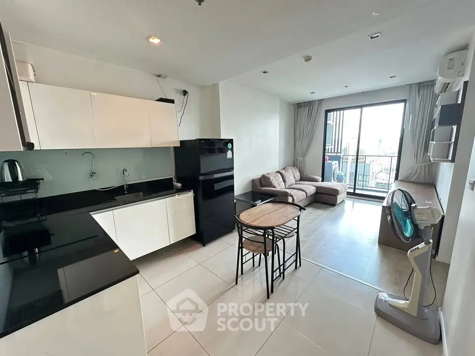 Modern open-plan kitchen and living room with balcony view
