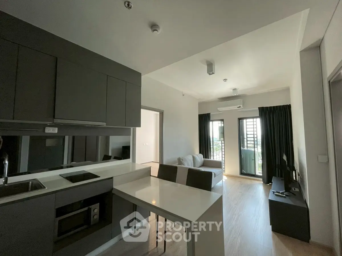 Modern open-layout kitchen and living room with sleek design and natural light