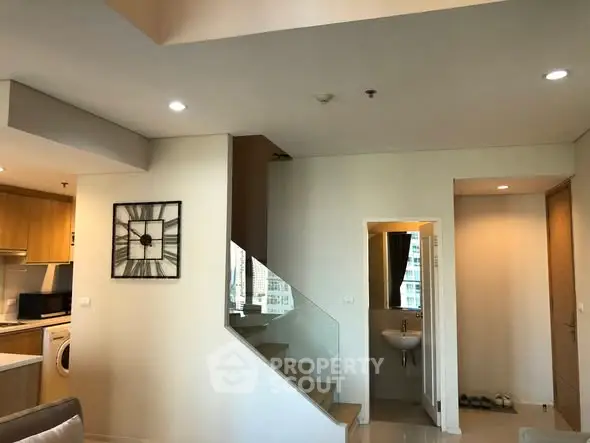 Modern duplex apartment with stylish staircase and open kitchen layout