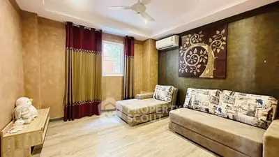Cozy living room with stylish decor and natural light, featuring comfortable seating and elegant wall art.