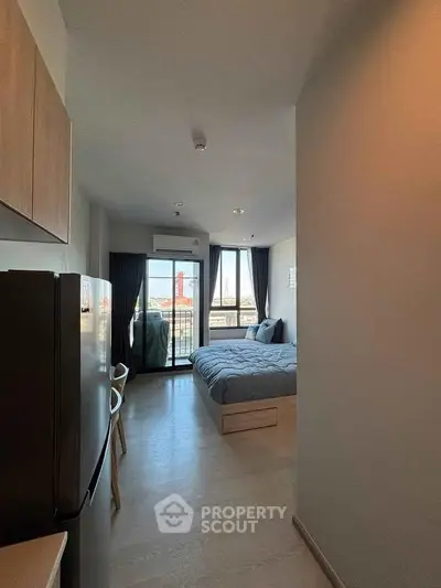 Modern apartment interior with cozy bedroom and balcony view, featuring sleek design and natural light.