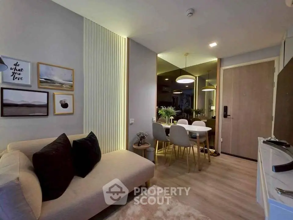 Modern living room with stylish decor and dining area in open layout apartment.