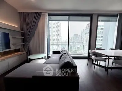 Modern living room with large windows and city view, featuring sleek furniture and elegant decor.
